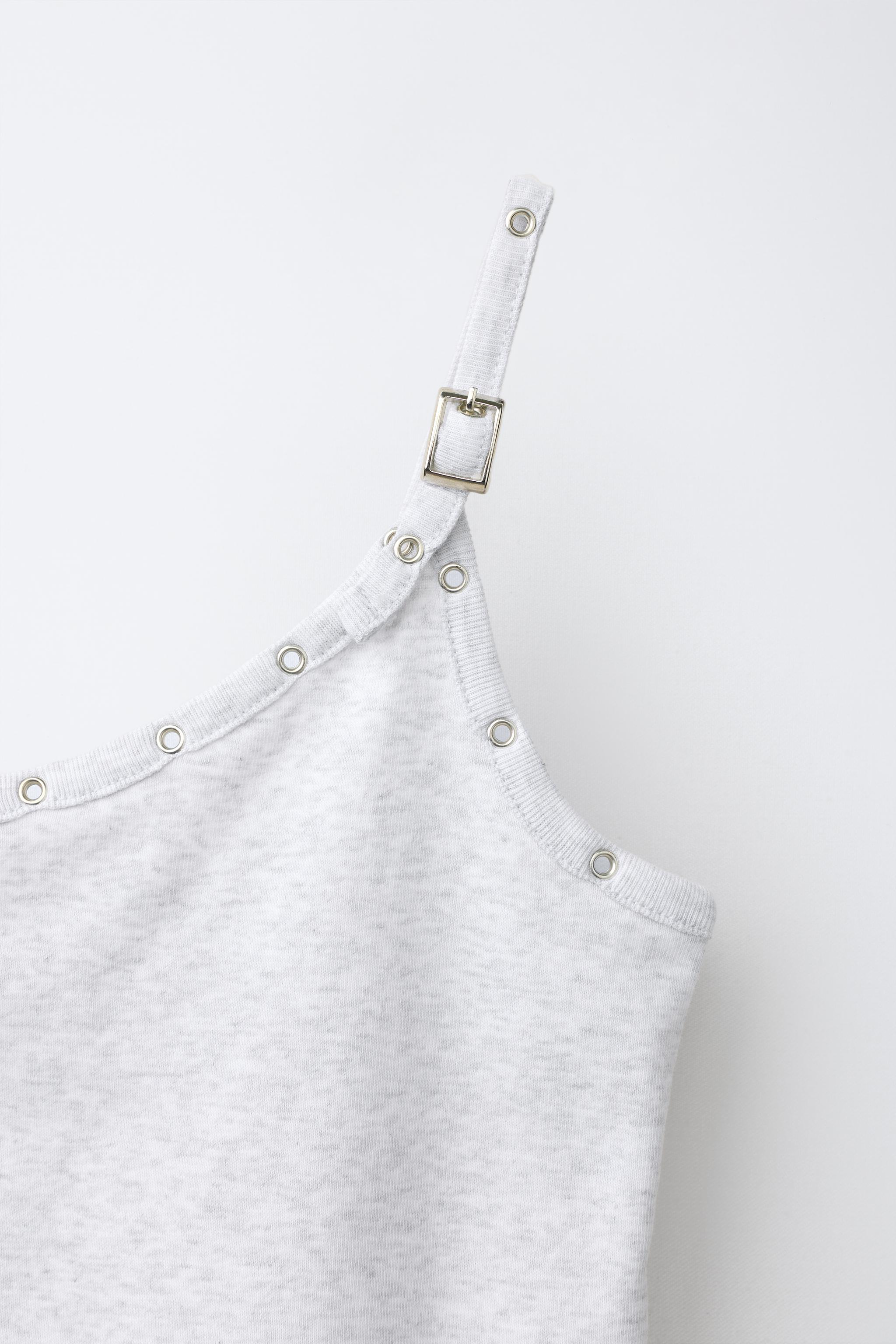 ASYMMETRIC BUCKLE TOP